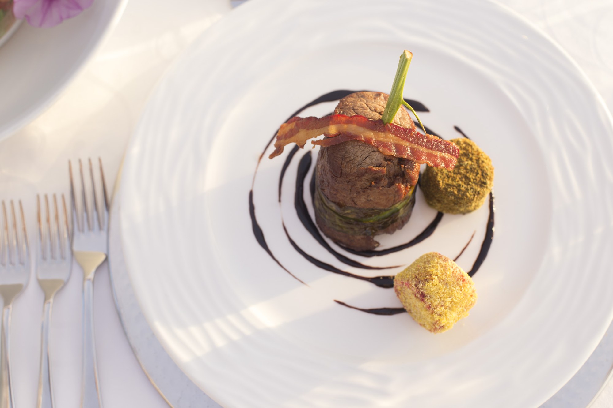 Foie Gras-Stuffed Beef Tenderloin — wrapped leek, crispy pancetta, toasted nut-crusted polenta & cassava, Cabernet–balsamic jus