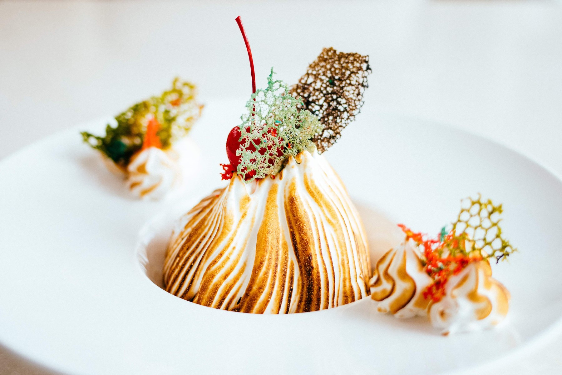 Table Flambéed Baked Alaska, a classic at Opera Hotel Kyiv — Madagascar vanilla parfait, Sicilian pistachio gelato, amarena cherry sorbet, Italian meringue